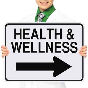 Worksite healthcare professional holding a sign that reads: Health and Wellness